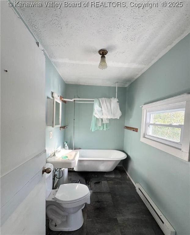 bathroom featuring baseboard heating, a textured ceiling, sink, toilet, and a bathing tub