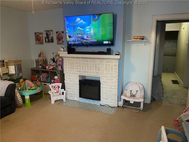 living room with carpet flooring and a brick fireplace