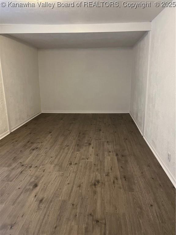 spare room with dark hardwood / wood-style flooring