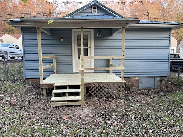 rear view of property with a wooden deck