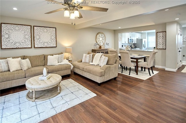 living room featuring beamed ceiling, dark hardwood / wood-style floors, and ceiling fan