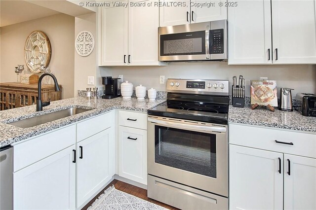 kitchen with white cabinetry and appliances with stainless steel finishes