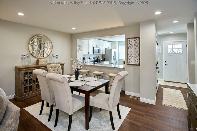 dining area with sink and dark hardwood / wood-style floors