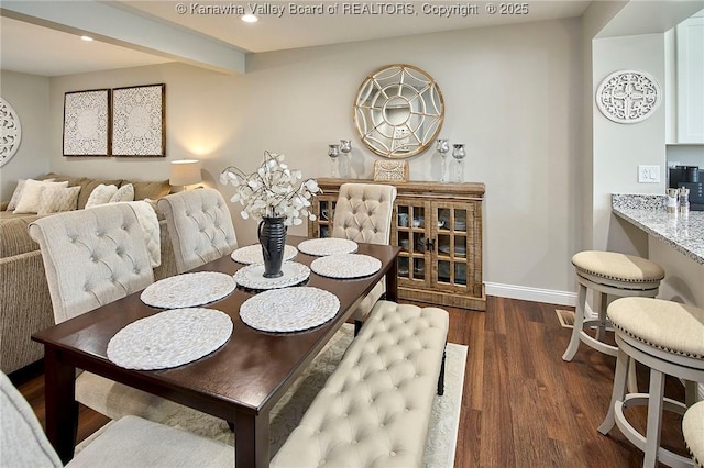 dining room featuring beam ceiling and dark hardwood / wood-style floors