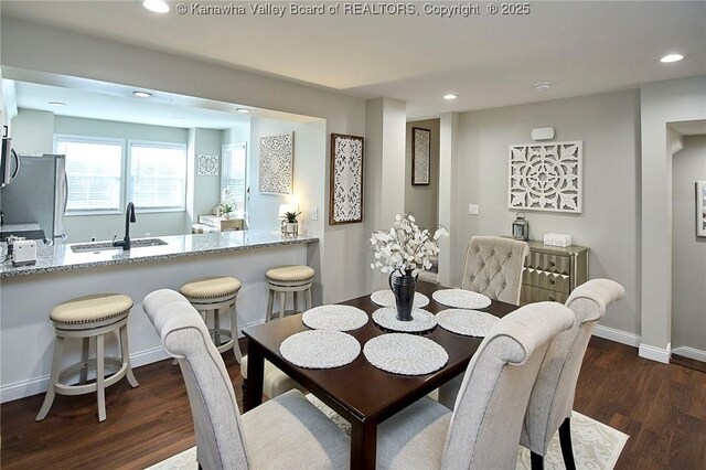 dining space with dark hardwood / wood-style flooring and sink