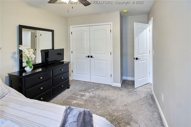 bedroom featuring light carpet, a closet, and ceiling fan