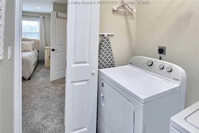 washroom with washing machine and clothes dryer and carpet