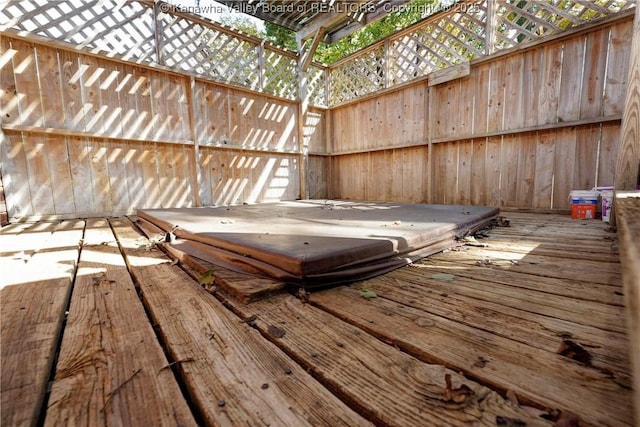 wooden terrace with a covered hot tub