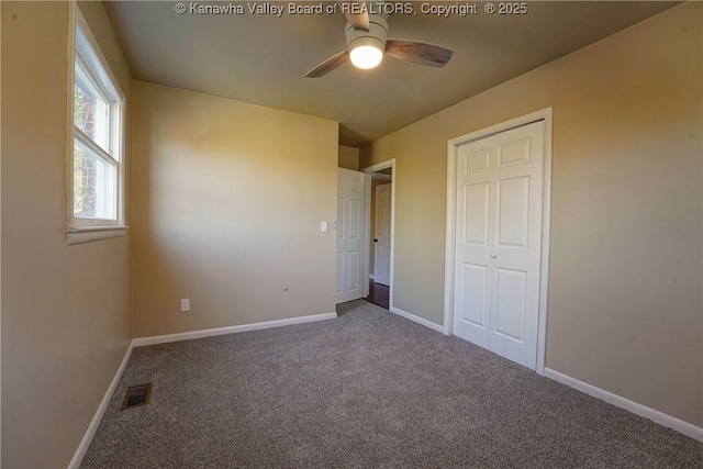 unfurnished bedroom with ceiling fan, a closet, and carpet floors