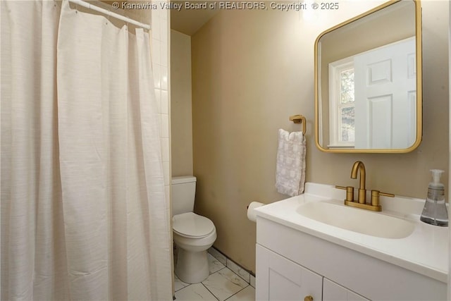 bathroom featuring vanity, toilet, and curtained shower