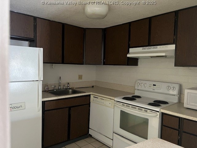 kitchen featuring sink, white appliances, and dark brown cabinets