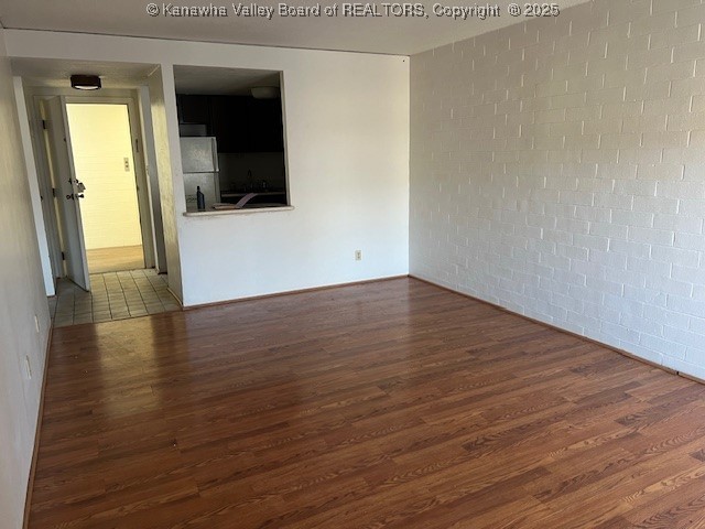 empty room featuring dark hardwood / wood-style flooring