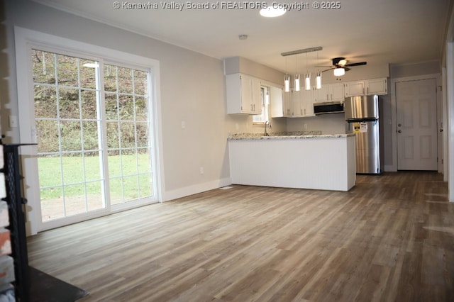 kitchen with white cabinetry, ceiling fan, kitchen peninsula, and appliances with stainless steel finishes