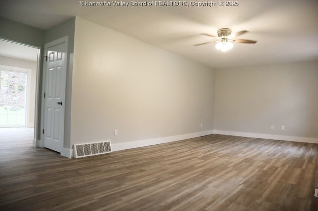 empty room with dark wood-type flooring and ceiling fan