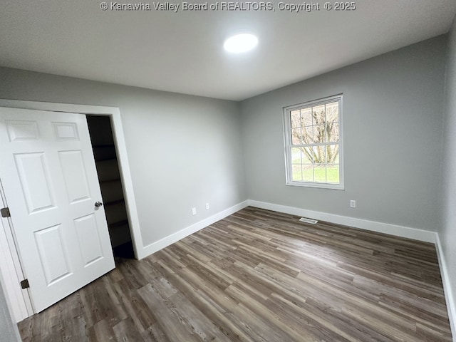 unfurnished bedroom with hardwood / wood-style floors