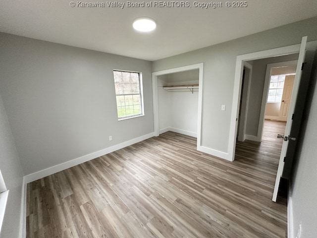 unfurnished bedroom with a closet and hardwood / wood-style floors