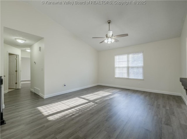 spare room featuring dark hardwood / wood-style flooring, ceiling fan, and vaulted ceiling