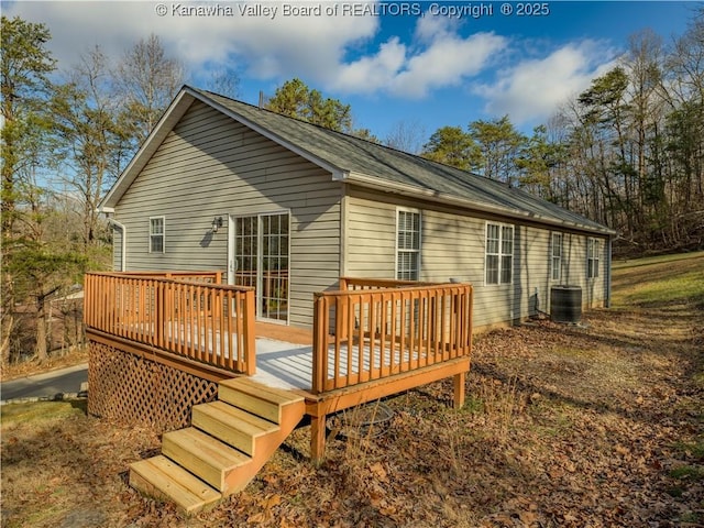 rear view of property featuring cooling unit and a deck