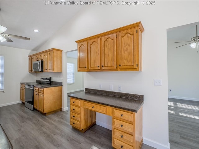 kitchen featuring appliances with stainless steel finishes, ceiling fan, hardwood / wood-style floors, and lofted ceiling