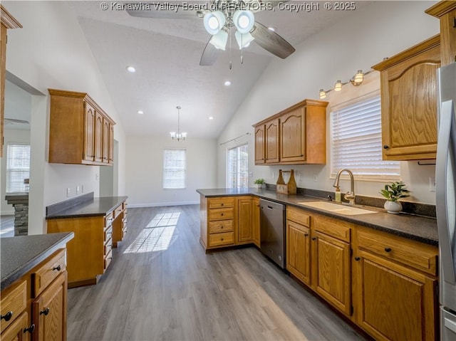 kitchen featuring light hardwood / wood-style floors, sink, decorative light fixtures, stainless steel dishwasher, and ceiling fan with notable chandelier