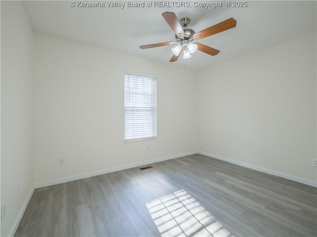 empty room with wood-type flooring and ceiling fan