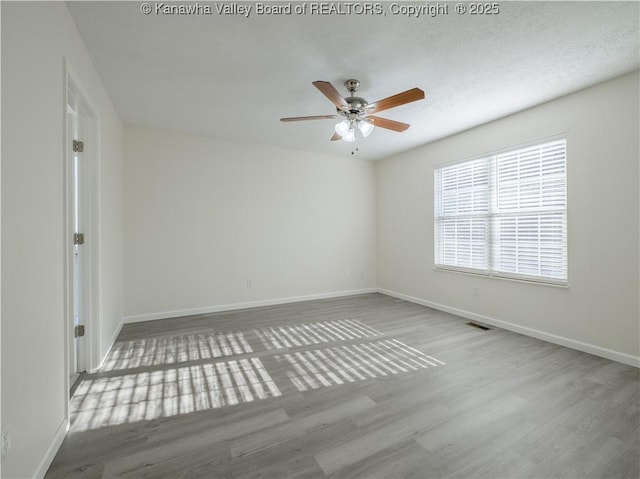 unfurnished room featuring hardwood / wood-style floors and ceiling fan