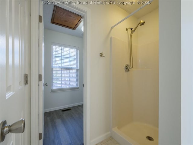 bathroom with a shower and hardwood / wood-style flooring