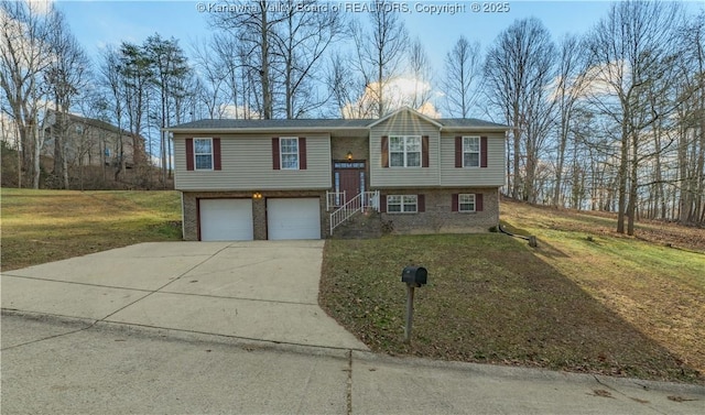 split foyer home featuring a garage and a front lawn