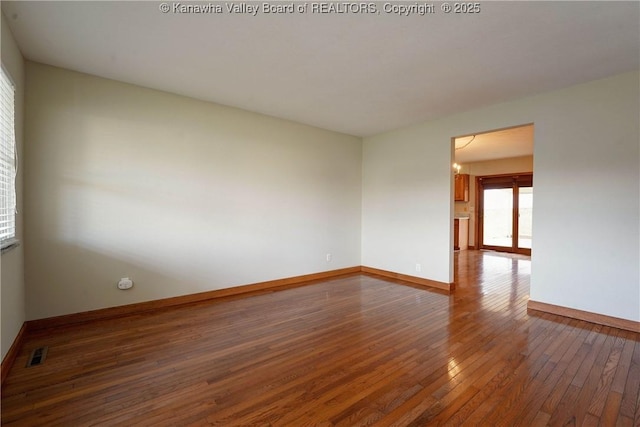 empty room with french doors and dark hardwood / wood-style flooring