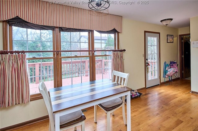 dining space with light hardwood / wood-style floors