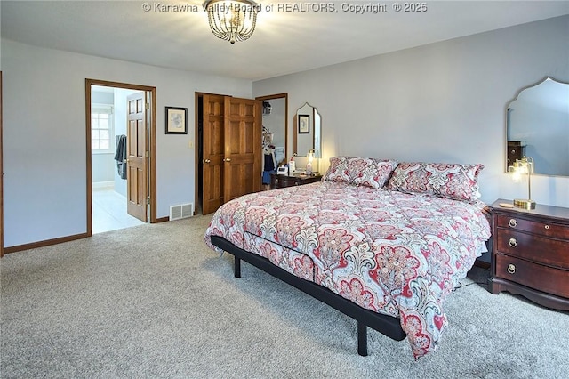 carpeted bedroom featuring ensuite bathroom