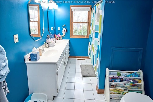 bathroom with vanity, tile patterned flooring, toilet, and curtained shower