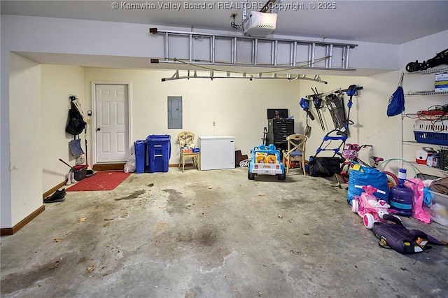 garage with a garage door opener, refrigerator, and electric panel