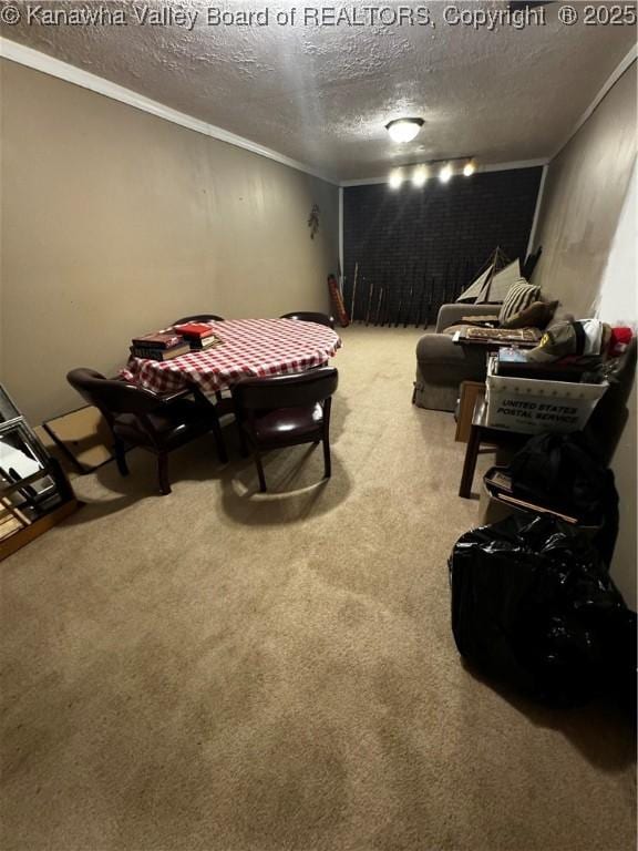 rec room featuring a textured ceiling, crown molding, and carpet