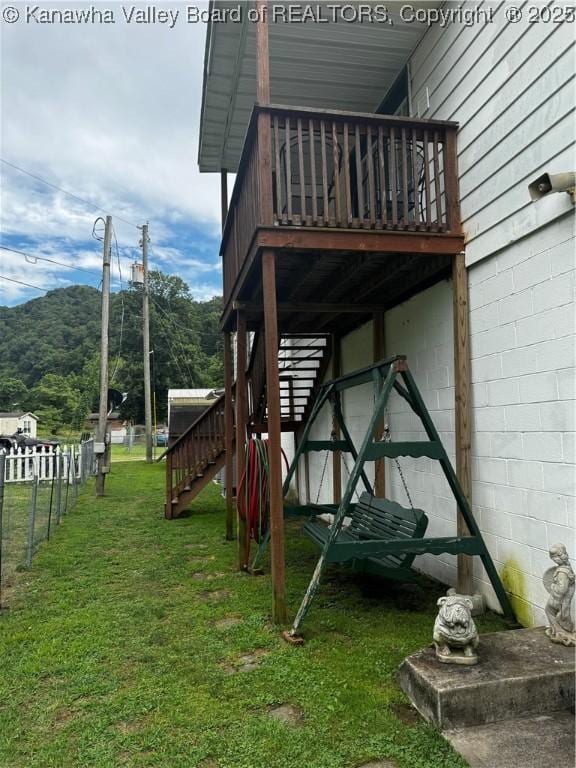 view of yard featuring a deck with mountain view