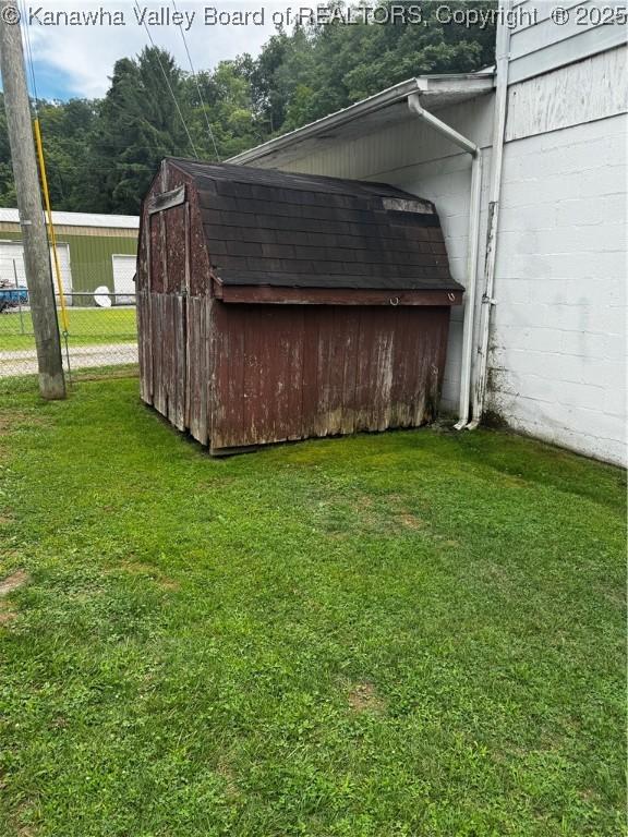 exterior space with a yard and a storage shed