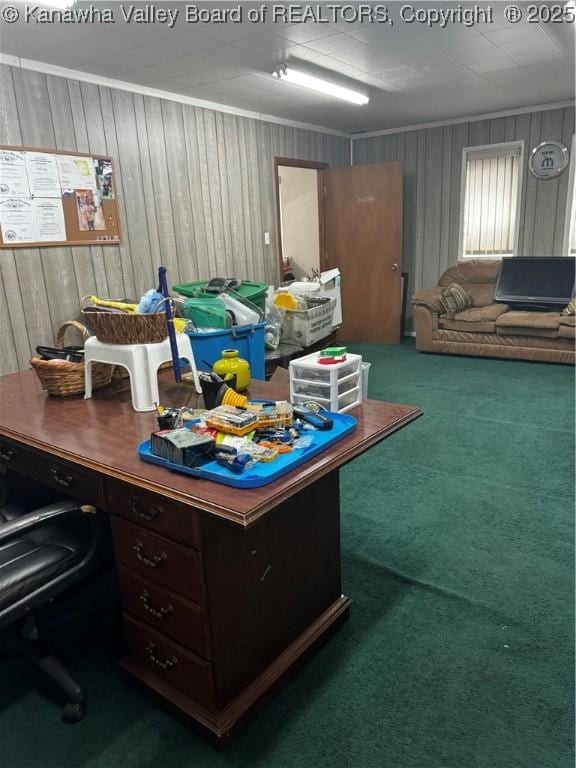 carpeted office space with wooden walls and crown molding