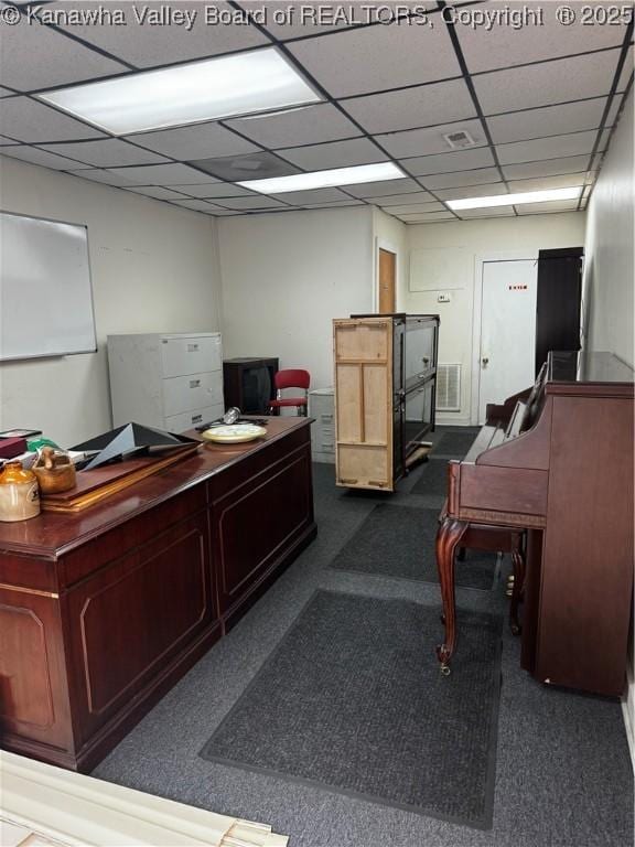 carpeted office space featuring a drop ceiling