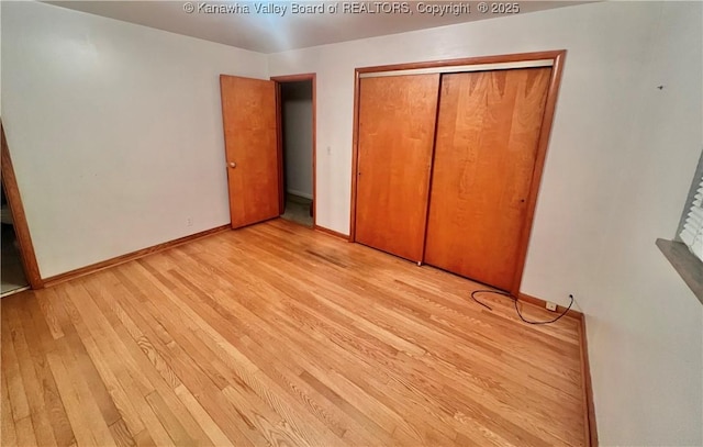 unfurnished bedroom featuring a closet and light hardwood / wood-style floors