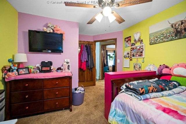 carpeted bedroom featuring a closet and ceiling fan