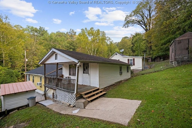 exterior space with a porch, cooling unit, and a yard