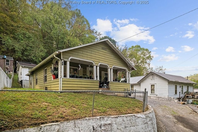 bungalow-style home with a porch and a front lawn