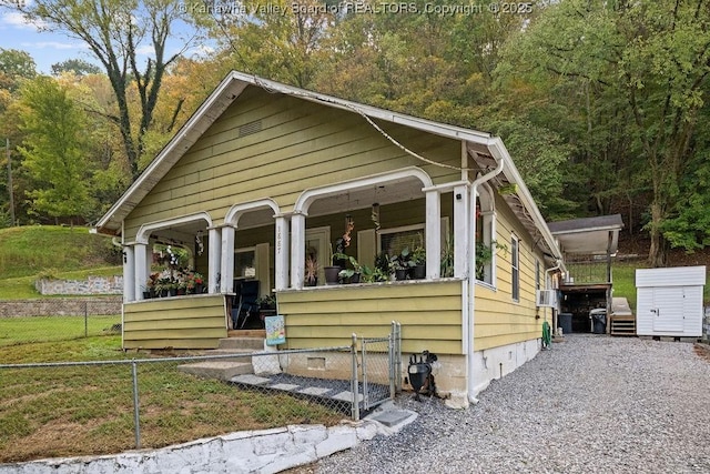 view of front of house featuring cooling unit and covered porch