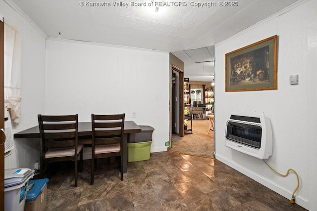 carpeted dining area featuring crown molding and heating unit