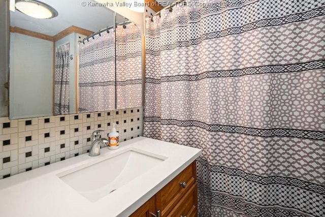 bathroom featuring vanity and tasteful backsplash