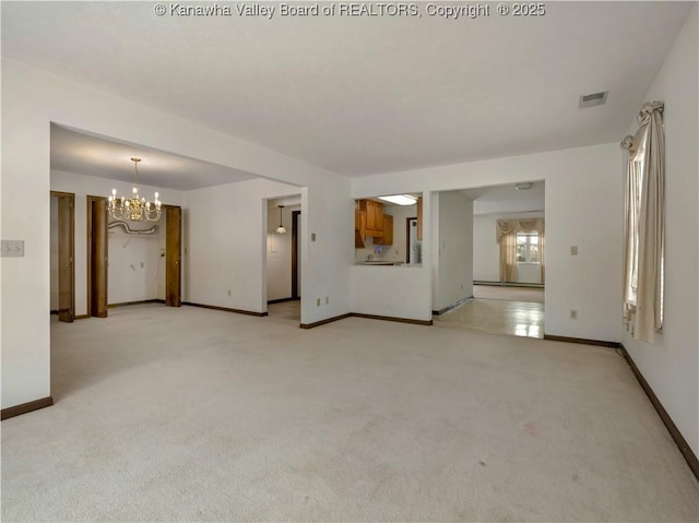 carpeted empty room with a baseboard radiator and a chandelier