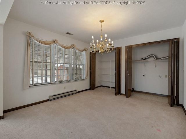 unfurnished bedroom featuring a baseboard heating unit, an inviting chandelier, and carpet flooring