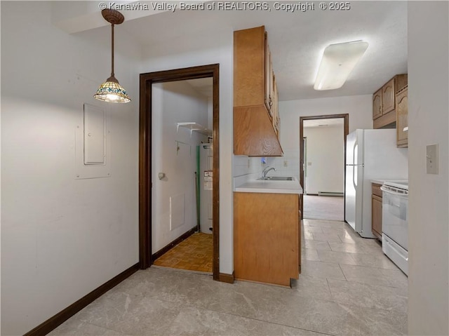 kitchen with hanging light fixtures, sink, white appliances, and water heater