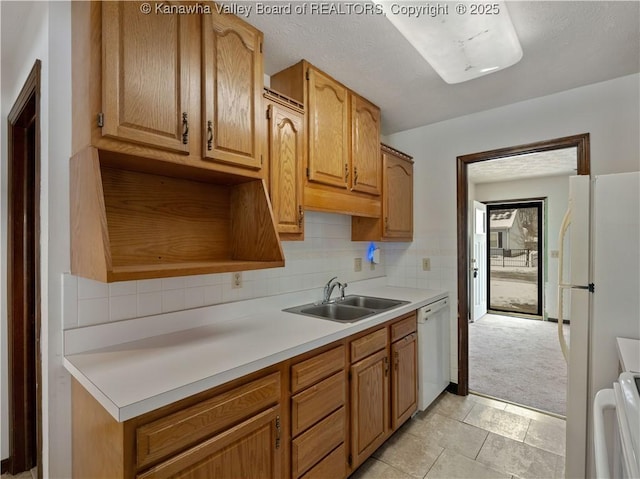 kitchen with sink, light carpet, white appliances, and decorative backsplash