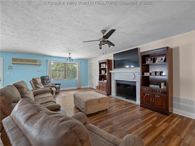 living room featuring hardwood / wood-style flooring, a textured ceiling, and ceiling fan